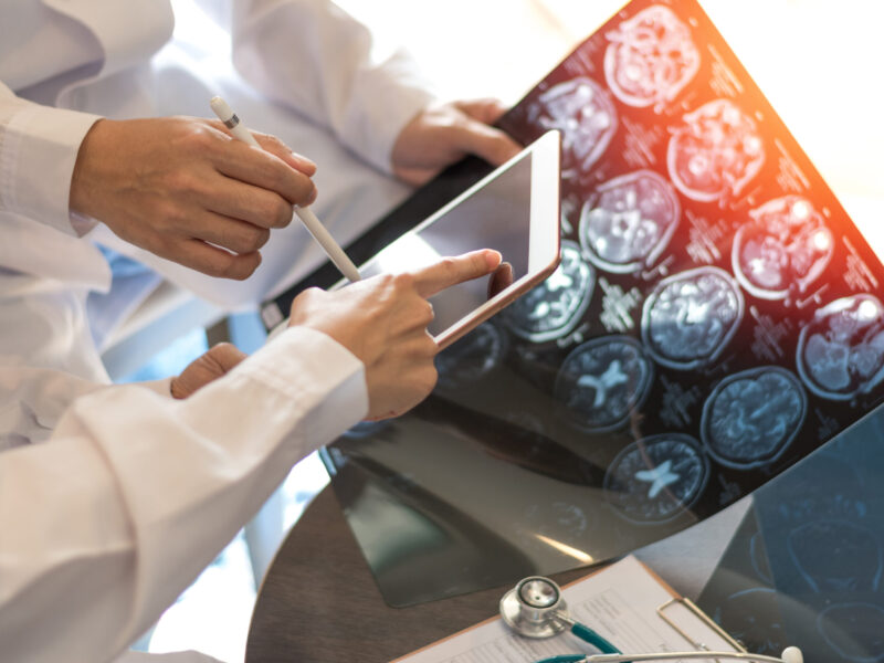 Doctors making notes on the results of a scan