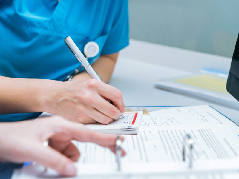 Doctor writing on a form